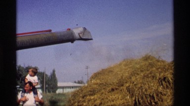 1969: kid plays with parent and machining runs MABEL MINNESOTA