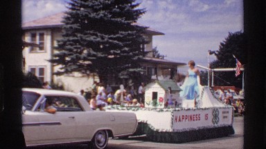 1969: A Pretty Lady in a Blue Dress Waves to the Crowd from the Top of Her Float