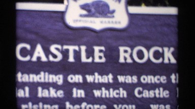 1969: Natural Rock Formation with Plaque and Leafy Trees in Wisconsin