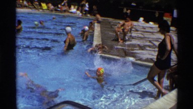 1971: kids are playing in swimming pool in amusement park water filled in pool