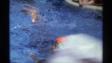 1971: Children and Parents Swimming in a Pool While Enjoying Warm Weather