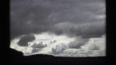 1969: a cloudy gray colored sky before rainy climate captured with road path