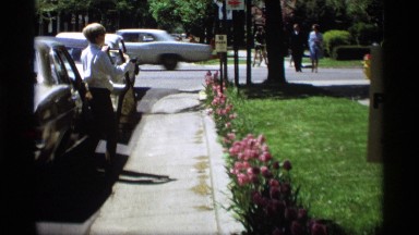 1969: a man parking the car go the near park another side come to the two car