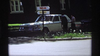 1969: two cars are moving one by one and a couple send off the cars