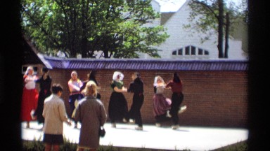 1969: ladies dance with joy lifting their legs ,in circles. HOLLAND MICHIGAN
