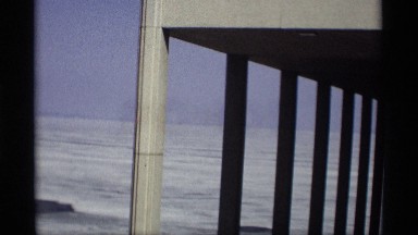 1966: one building in pillar model in front with trees and another pillars