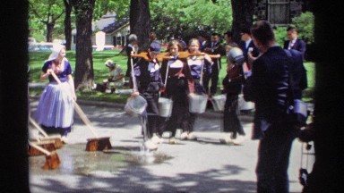 1969: people are outside in a park spreading water and cleaning up