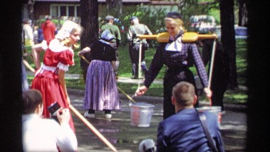 1969: two ladies are providing water from their bucket to a man