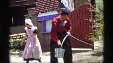 1969: the men and women long rubber pipe to take the water the silver pot