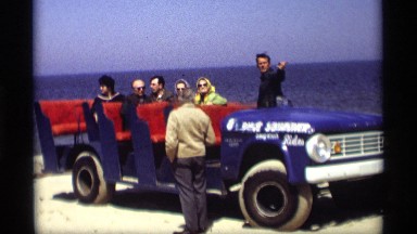 1969: a group of citizens on a trip enjoying the scenery as another explains
