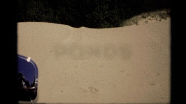 1969: we see people reflected in a side mirror of a driving car HOLLAND MICHIGAN