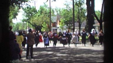 1969: people are held their hands and dancing an folk dance for an festival