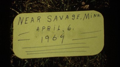 1969: a sign of place on year 1969 april 6, a man is getting on his car