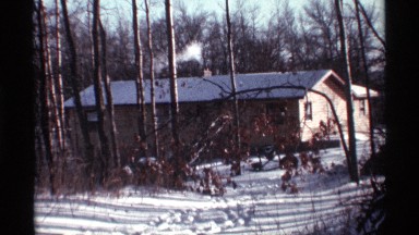 1968: smoking house chimney deep inside the woods and snow CHICAGO ILLINOIS
