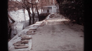 1969: rock lined river side path leading to business on the dock ROCKFORD