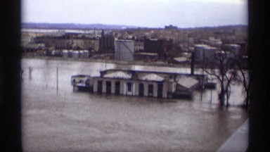 1969: a big house environ by flowing water on four sides and trees