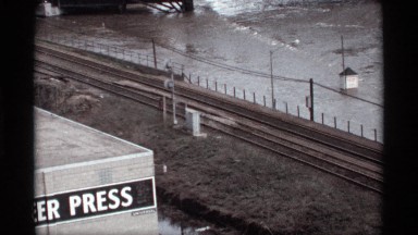 1969: one river move the fast near railway track and road the lorry right