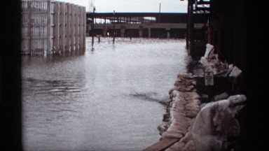 1969: steel cabin standing in center of water near to bridge at distance