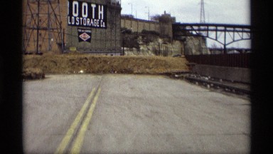 1969: a road with a board and then water with bridge two locations