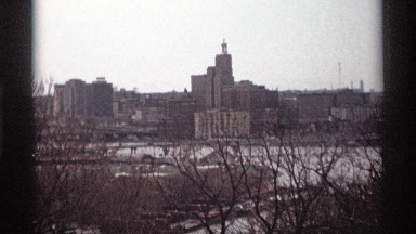 1969: distant video of city buildings, river, and trees in winter SAINT PAUL