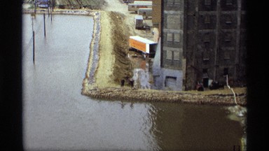 1969: a lake with full of water and some transport are standing outside