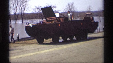 1969: the tractor is besides of the river and wait the few persons