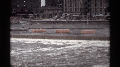 1969: foamy water sits on top of a roaring river as if flows in a canal SAVAGE