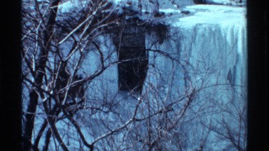 1968: vertical blades of ice hang over frozen structure except at openings