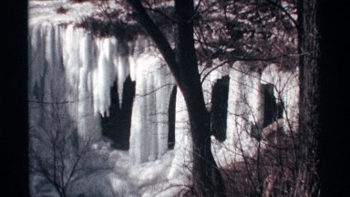 1968: connected icicles form frozen wall over side of dark structure CHICAGO