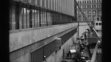 1968: a construction place that place some workers are doing work and taking