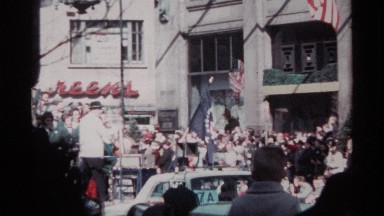 1968: a float driving through a crowd during a parade carrying a young band of