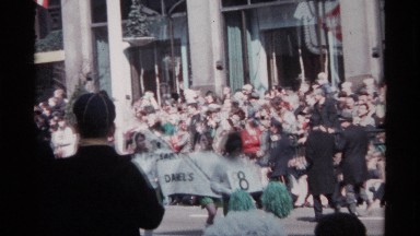 1968: parade scene from earlier era with children marching by twirling batons