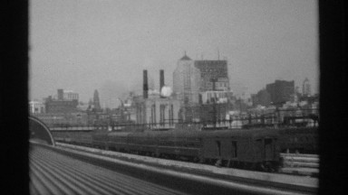 1968: excellent city view from atop a locomotive train while traveling slowly