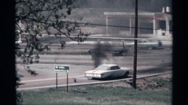 1968: car parked on the side of the road puffing out smoke due to fire. CHICAGO