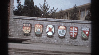 1974: A Colorful Wall Mural with Symbolic Icons and People Walking in Vancouver