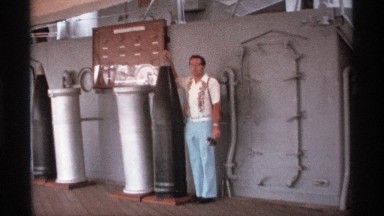 1974: A Young Man Waving Near Factory Machinery in Seattle