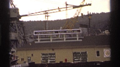 1974: a board at the top of a house roof and a iron vehicle also there near to