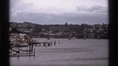 1974: a place of water area and looks like a lake and some wood stick also