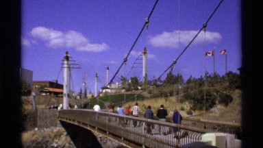 1974: people crossing a bridge with a canadian flag in the background WORLDS