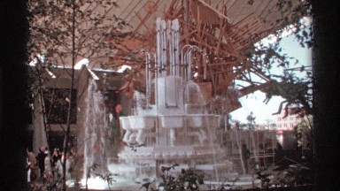 1974: Entertaining Water Fountain Spraying While a Group of People Watch