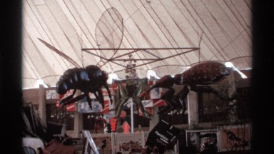1974: statue of spider and insects at a exhibition place and people are watching