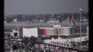 1967: A Busy City Street Scene with Moving Vehicles and Flags in Montreal