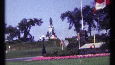 1967: a beautiful garden and a statue center of the garden a man walking there