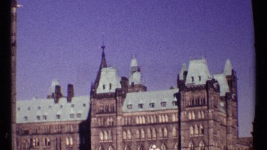 1967: Shiny Day Blue Sky in Front of a Very Large Castle with Blue Roof and Brown Buildings