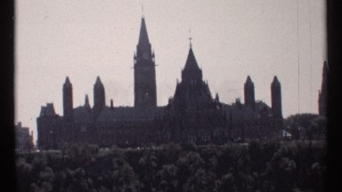 1967: Wide Ornate Building Sits in Front of Taller Clock Tower Ottawa
