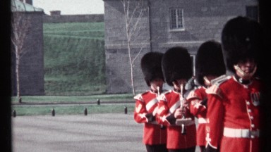 1967: a large group of people is walking in formation while some play