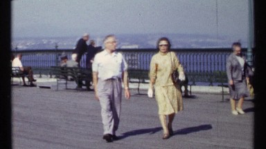 1967: a man and woman are dressed up and taking a stroll on a boardwalk by the
