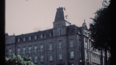 1967: a building with more apartments and a cute rooftop and trees also front of