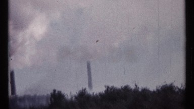 1967: white smoke is flowing upwards from three tall cylindrical chimneys OTTAWA