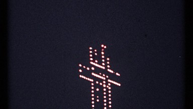 1967: giant jesus cross lighting up the night sky with multiple light bulbs